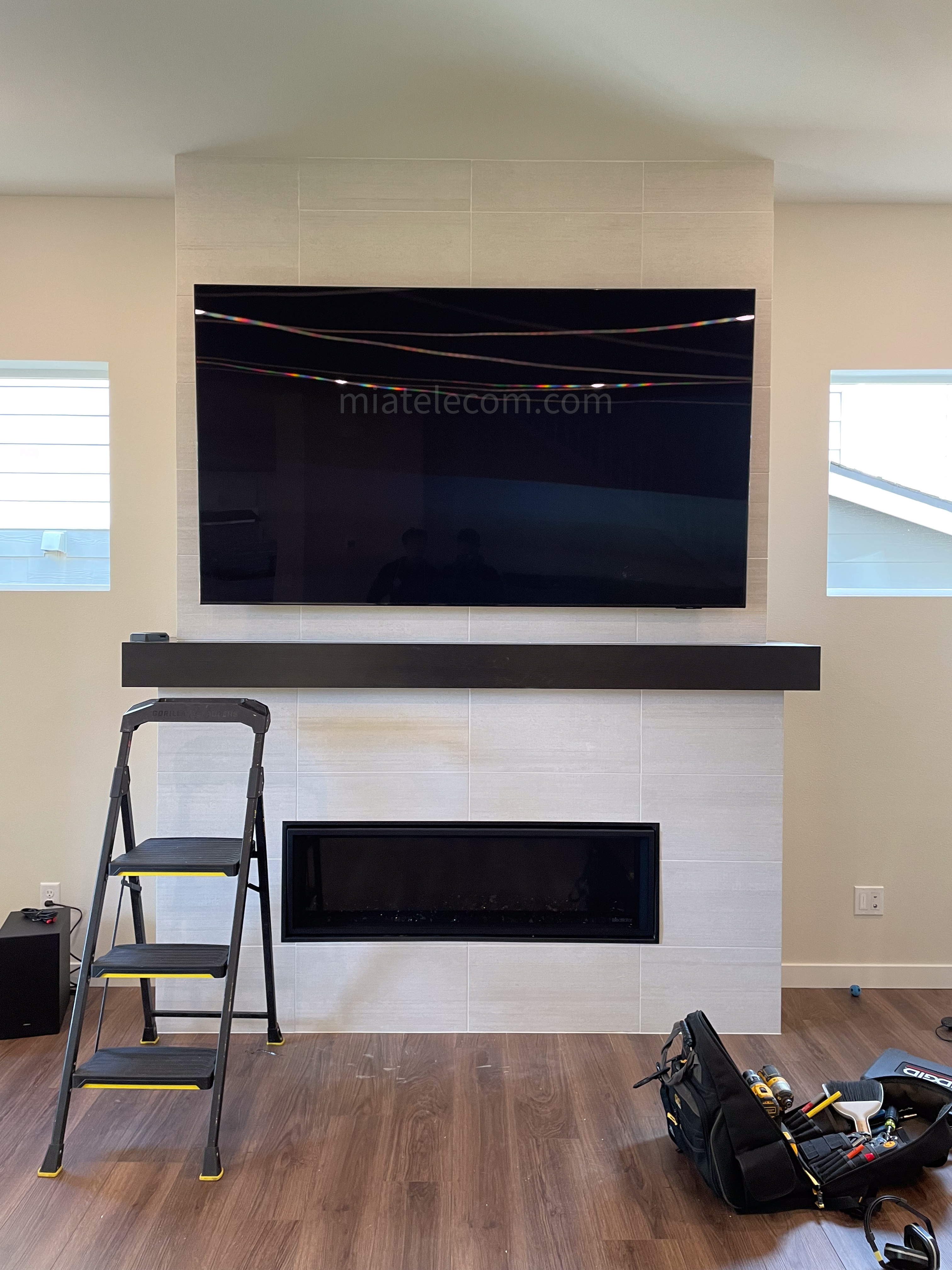 65'' on Tile Over the Fire Place w/ Cable arrangement